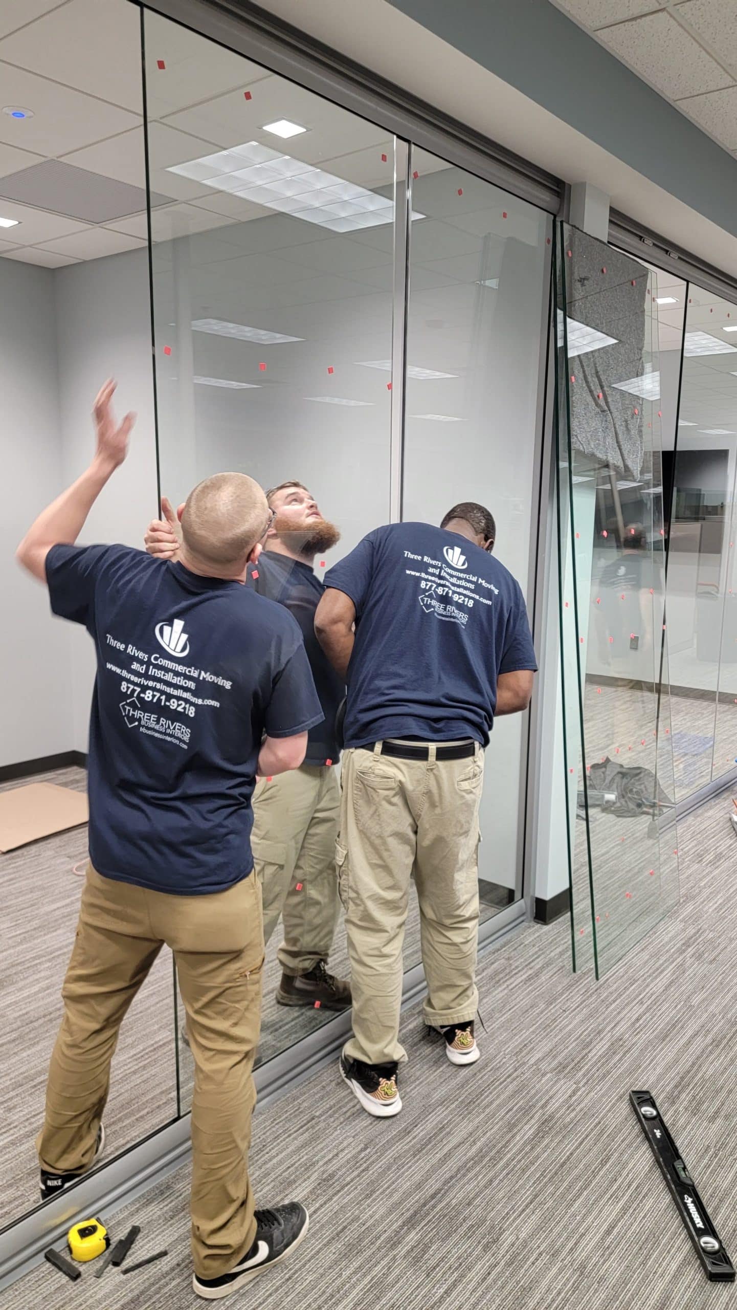 Wall Glass Installation by three guys at Three Rivers Installations in Fort Wayne, Indiana for an office space