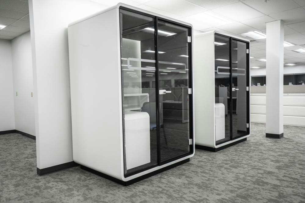 Two modern modular office within an office space in white and tinted windows
