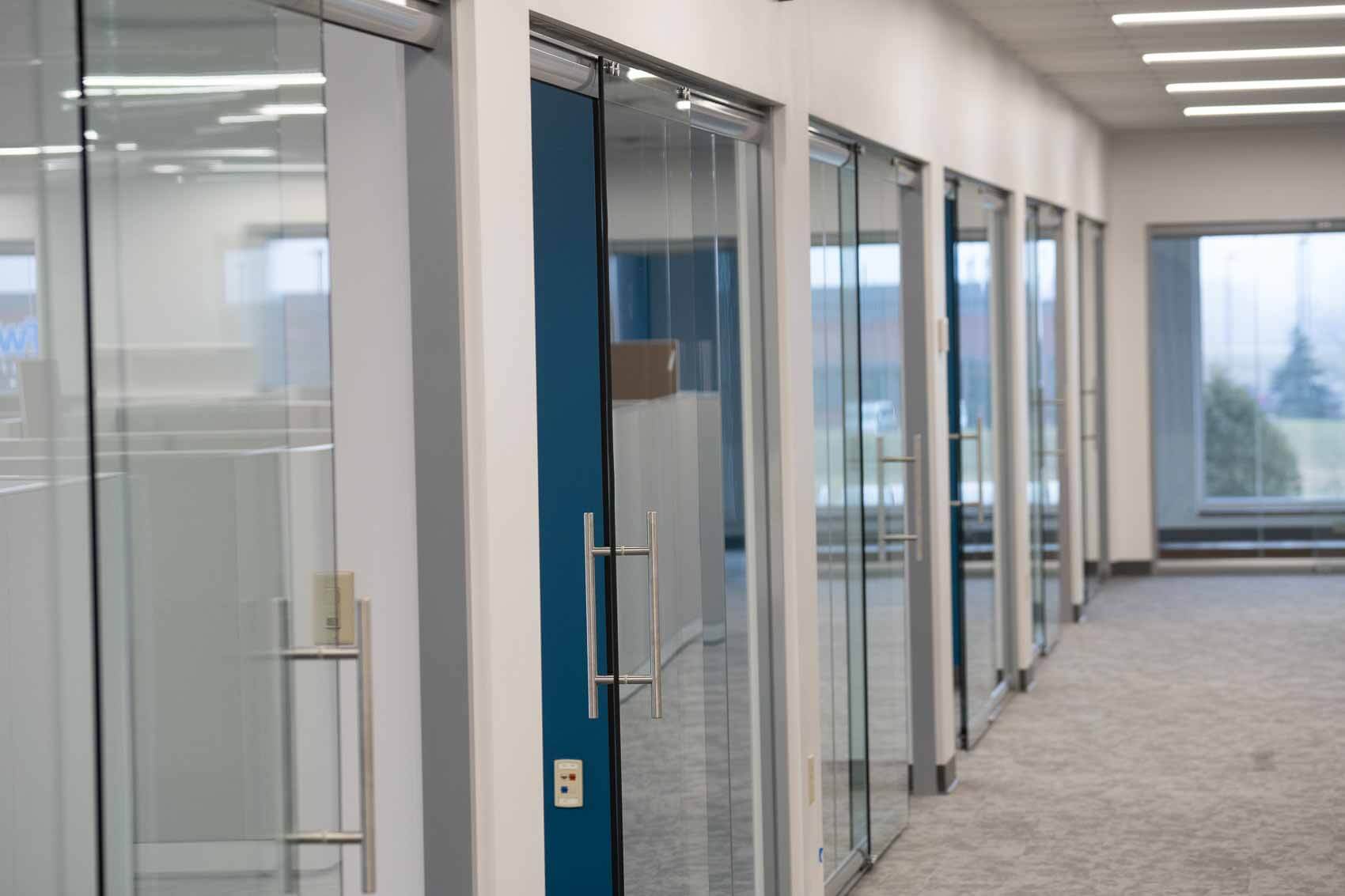 Installing Partition Walls and Clear Glass Doors in a Business Building Showing the Finished Design