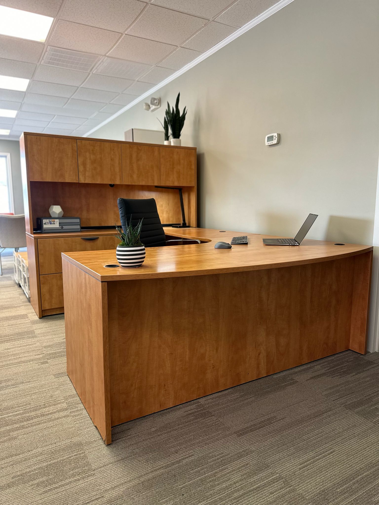 L Shape Desk showcased in a business retail store front for sale with light oak and attached hutch