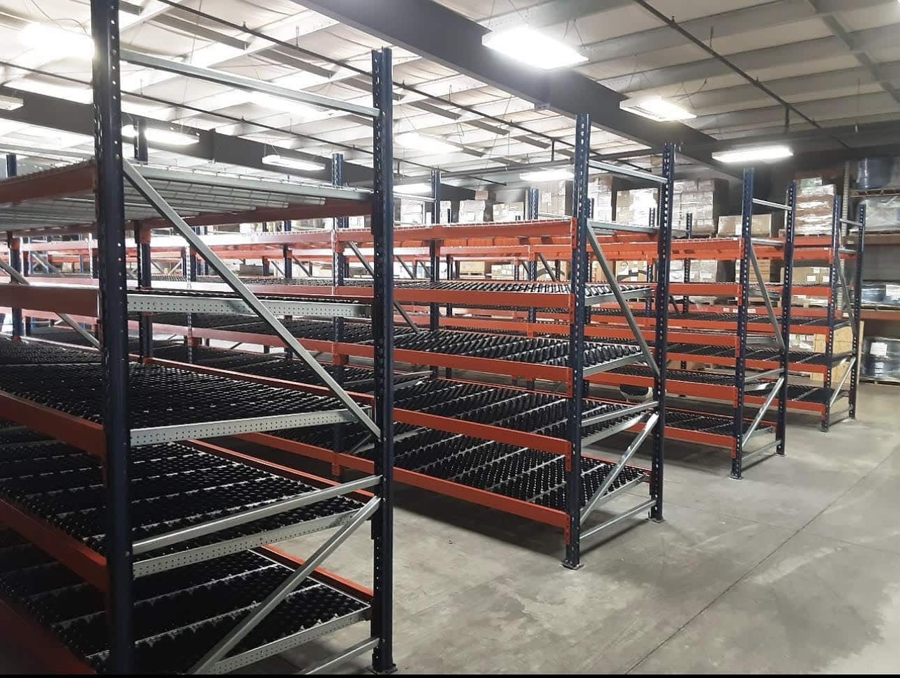 Warehouse racks of orange and green shelves